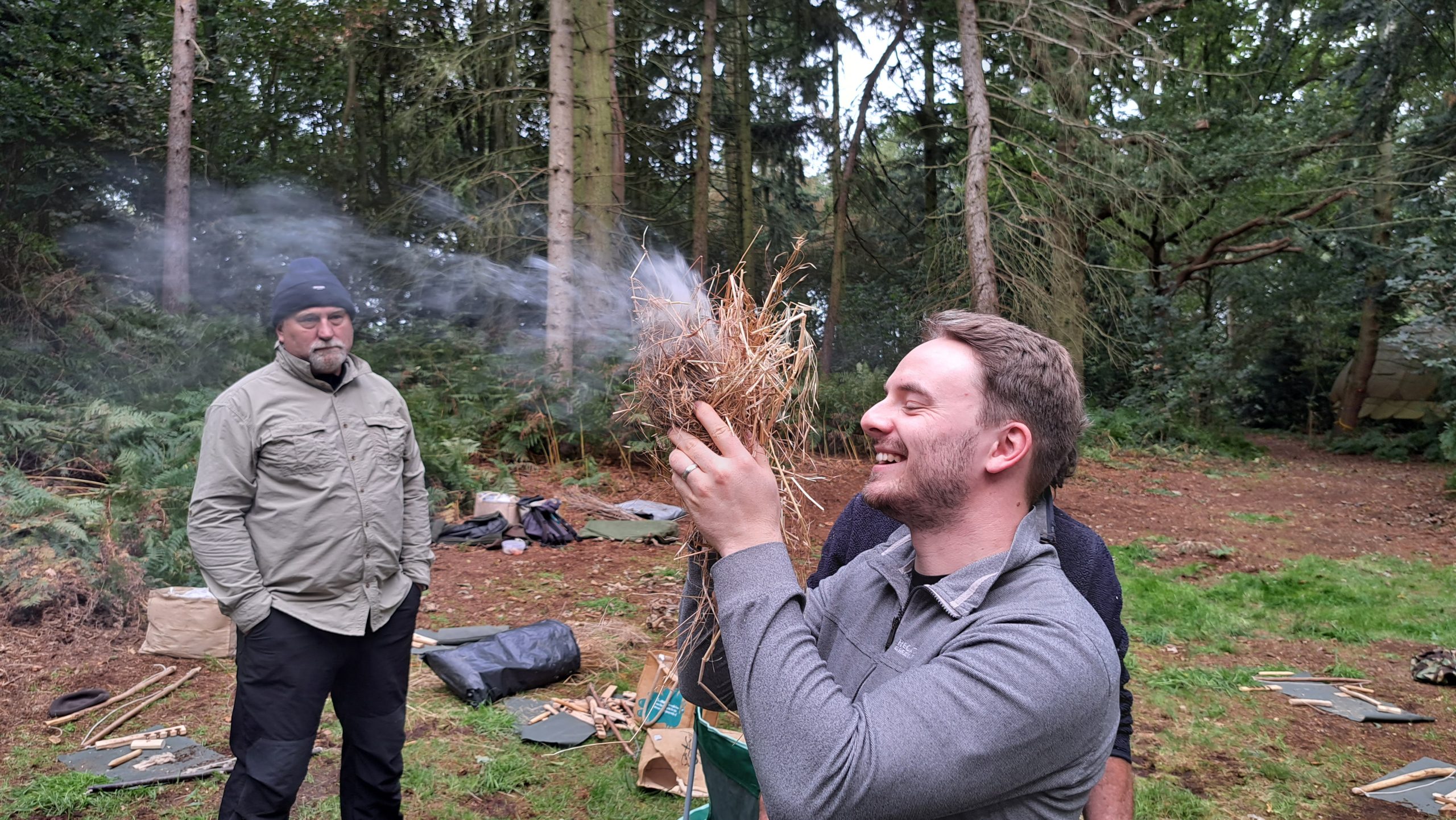 A man lighting a fire using traditional techniques